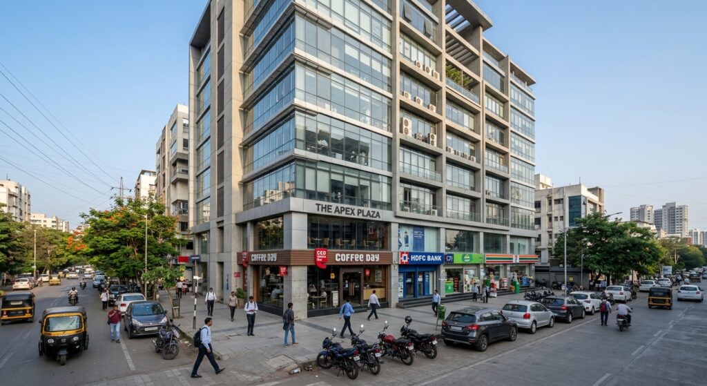 Photorealistic wide-angle photograph of a modern mid-rise commercial office building in an Indian metro city, ground-lev